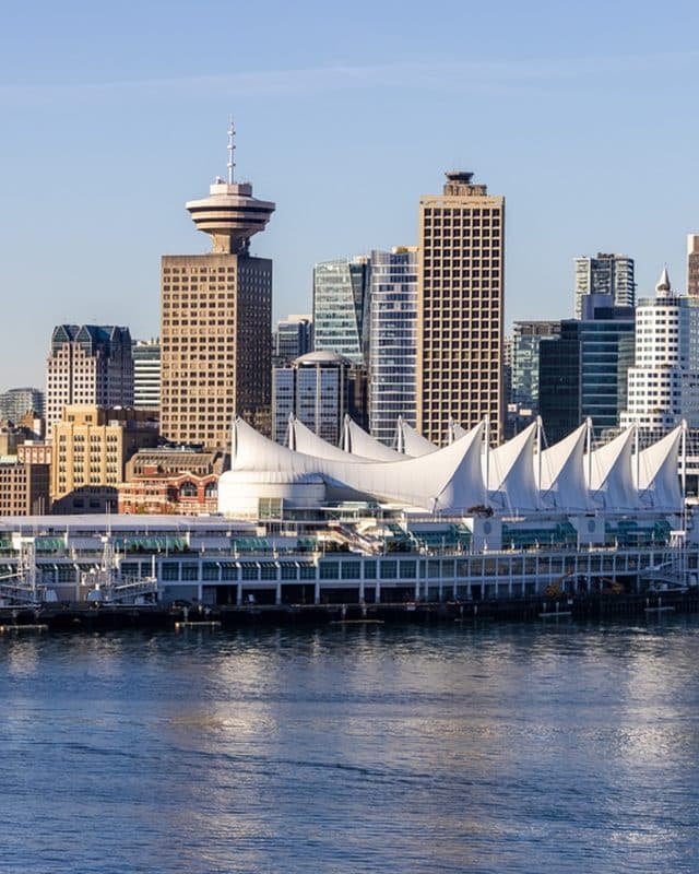 Canada Place sails on the harbour with the downtown skyline behind