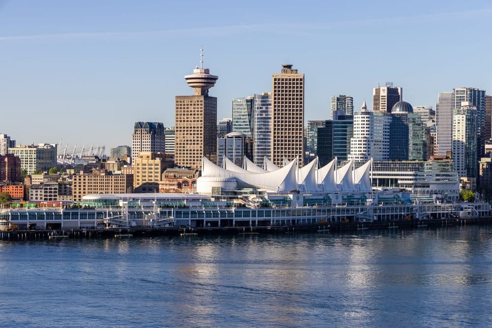 Canada Place sails on the harbour with the downtown skyline behind