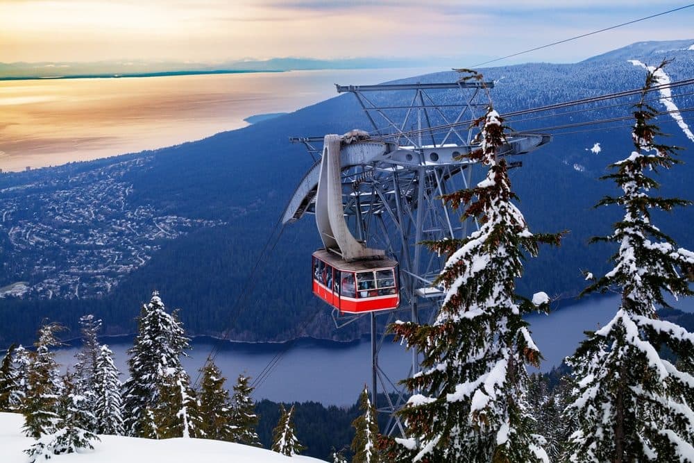 The Grouse Mountain Skyride over snowy forest, the city, and the Salish Sea