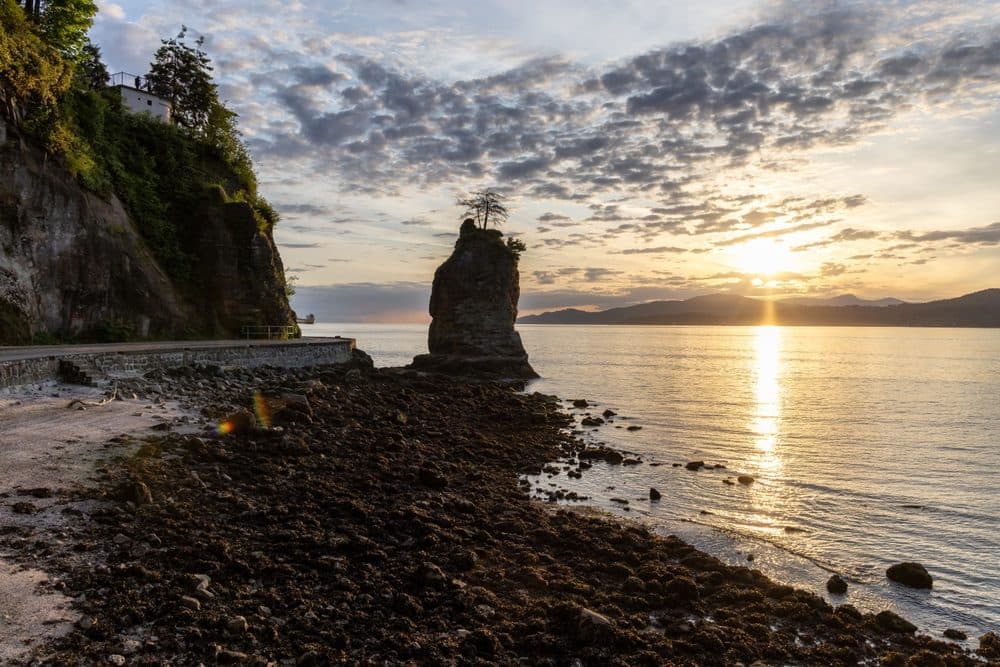 Siwash Rock from the Stanley Park shoreline at sunset