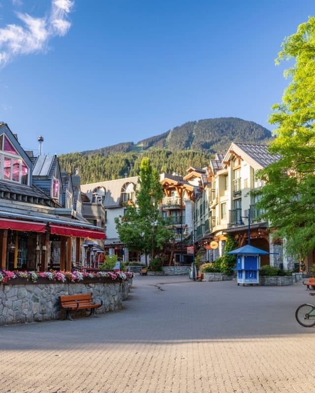 Whistler Village pedestrian plaza with Blackcomb mountain beyond