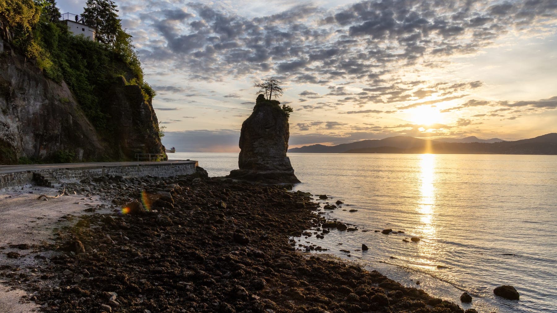 Siwash Rock from the Stanley Park shoreline at sunset