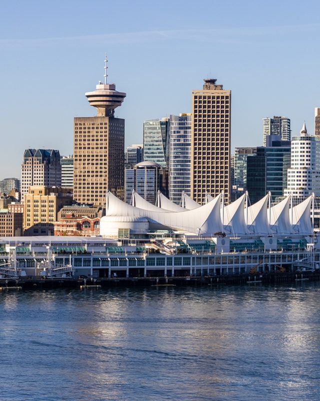 Canada Place sails on the harbour with the downtown skyline behind