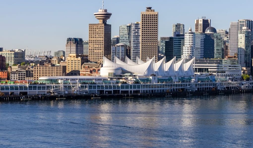 Canada Place sails on the harbour with the downtown skyline behind