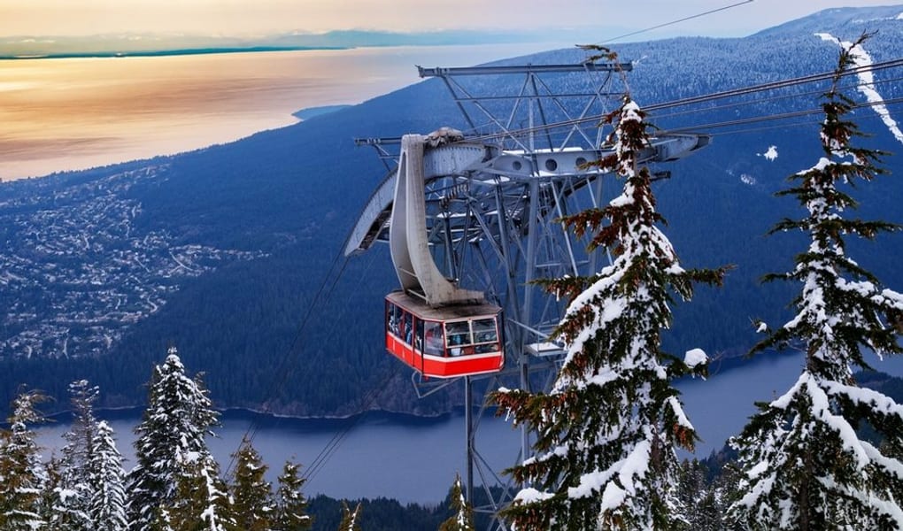 The Grouse Mountain Skyride over snowy forest, the city, and the Salish Sea