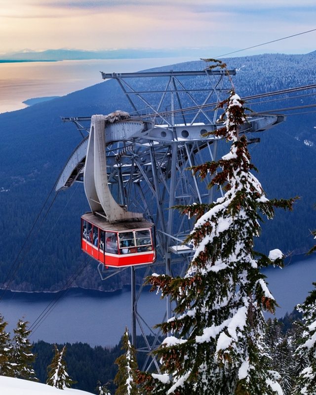 The Grouse Mountain Skyride over snowy forest, the city, and the Salish Sea