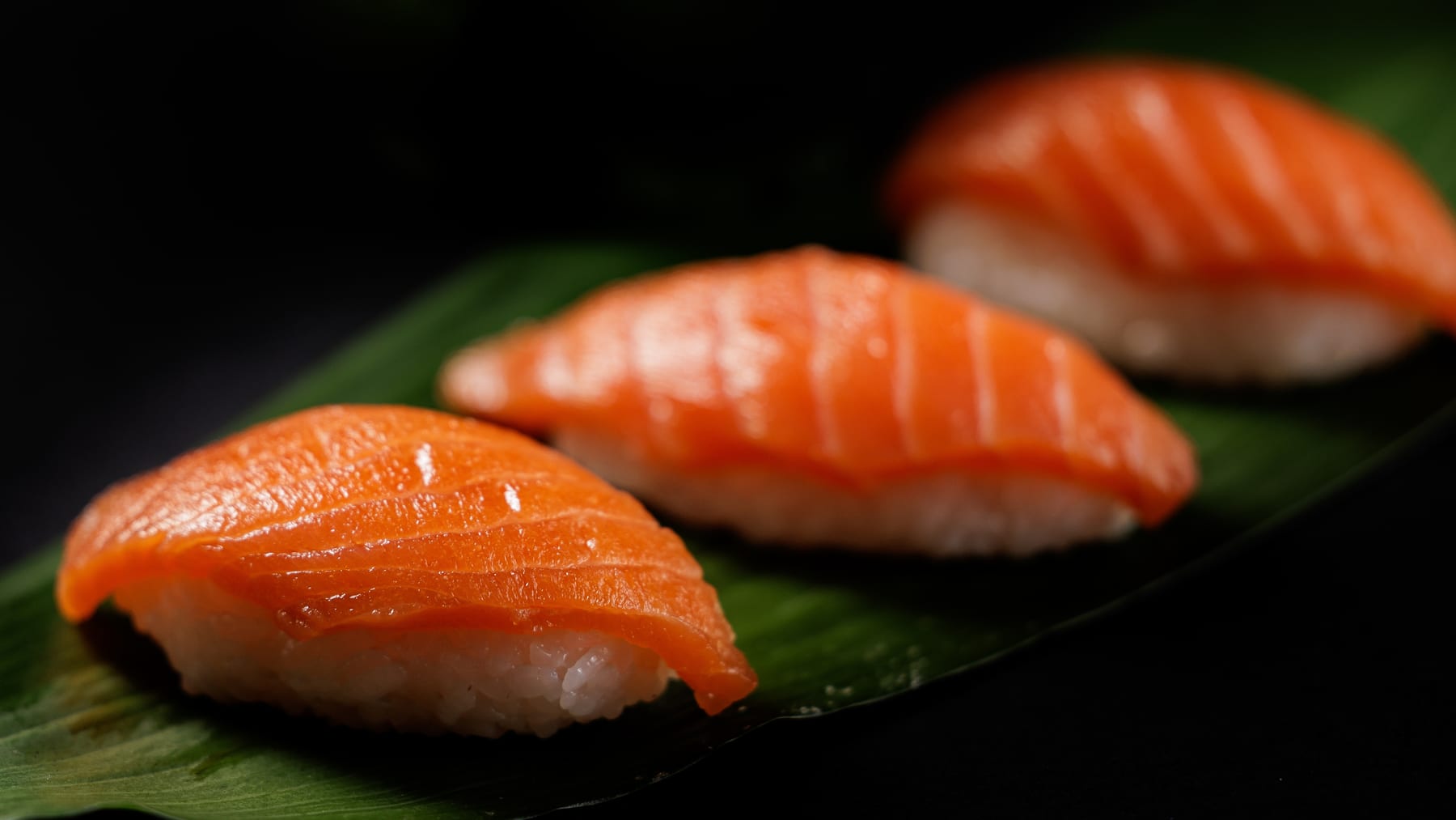 Nigiri sushi on a dark plate