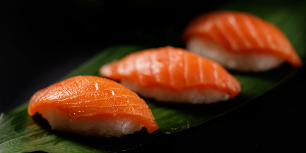 Nigiri sushi on a dark plate