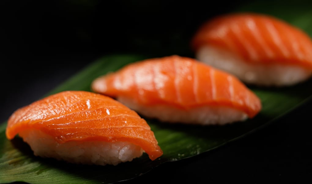 Nigiri sushi on a dark plate