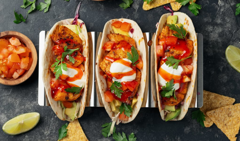 Street-style tacos on a metal tray