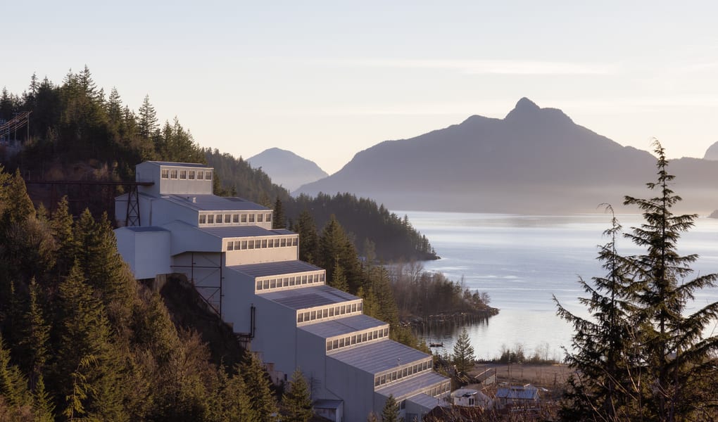 Historic industrial site beside mountains
