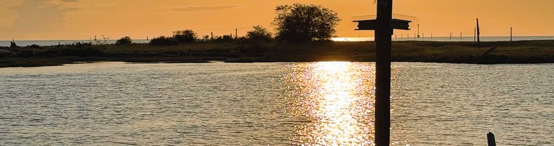 Siwash Rock from the Stanley Park shoreline at sunset