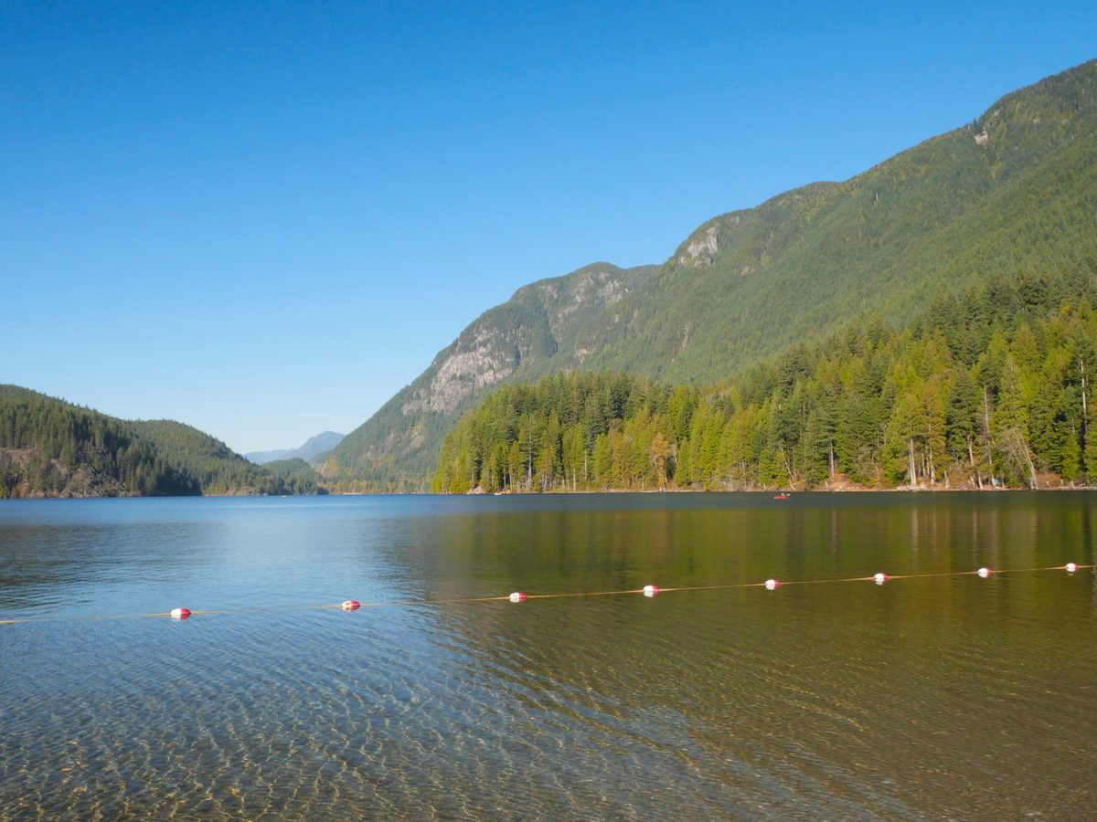 Buntzen Lake reservoir in Anmore, with a forested shore and still water