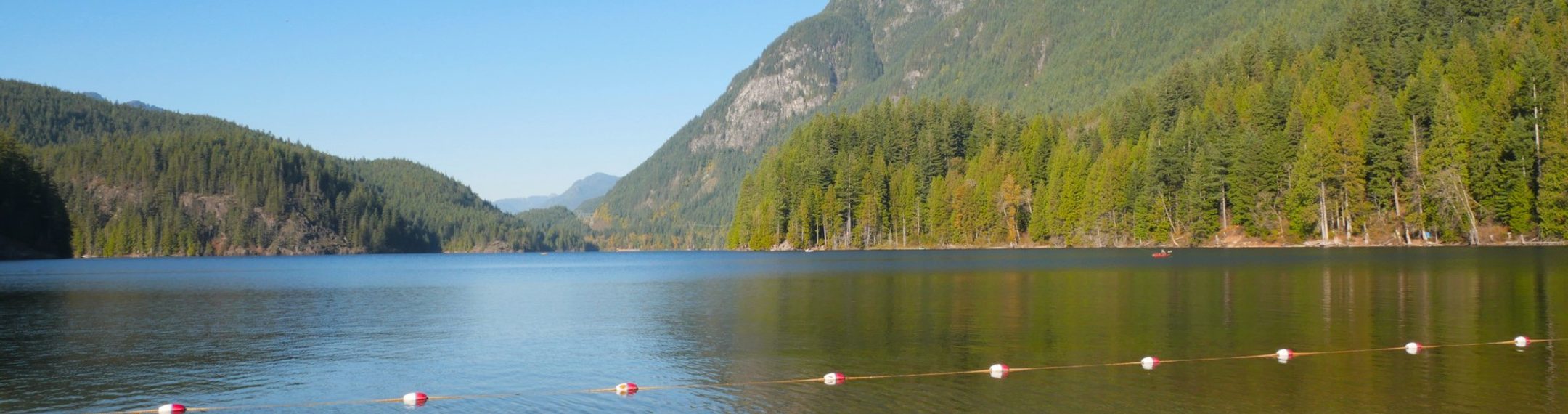 Buntzen Lake reservoir in Anmore, with a forested shore and still water
